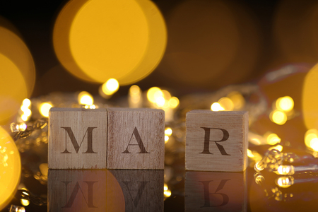 Month Concept, front view shows wooden block written Mar with light and bokeh backgroundの写真素材