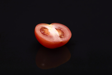Fresh tomato on black background.の写真素材