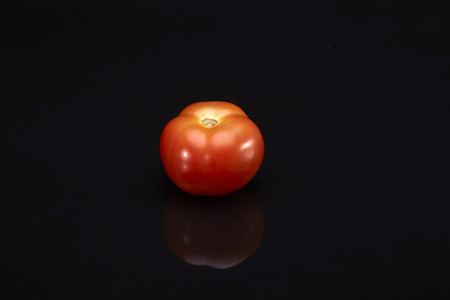 Fresh tomato on black background.の写真素材