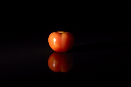 Fresh tomatoes on black background.の写真素材