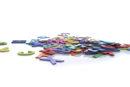 Pile of colorful wooden letters isolated over the white background with copyspaceの写真素材