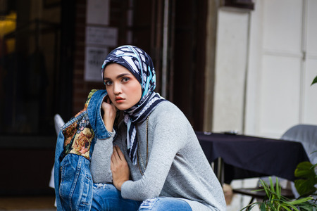 Beautiful young Muslim girl at town street .Close up portraiture shot with bokeh and blur city backgroundの写真素材