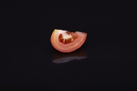 Fresh a slice tomatoes on black background.の写真素材