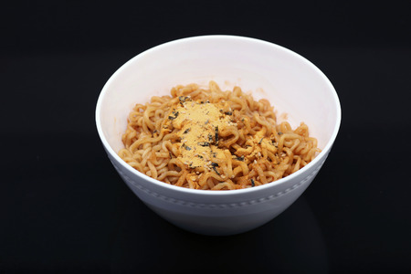 Cheese ramen noodles on black backgroundの写真素材