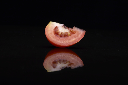 Fresh tomatoes on black background.の写真素材