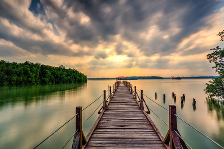 Beautiful long exposure sunrise shot at jetty. Image contain certain grain or noise and soft focus when view at full resolutionの写真素材
