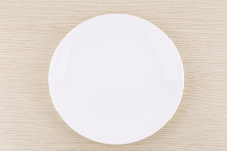 White plate at wooden backgroundの写真素材