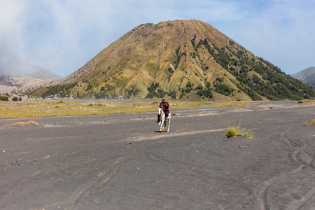 BROMO, INDONESIA - 9th May 2018; unidentified local people or Bromo Horseman pose for camera at the mountainside of Mount Bromo, Semeru, Tengger National Park, Indonesiaのeditorial素材