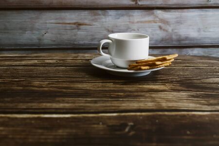 Chrysanthemum  tea in cup with biscut over the  old wooden table background . selective focusの写真素材
