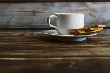 Chrysanthemum  tea in cup with biscut over the  old wooden table background . selective focusの写真素材