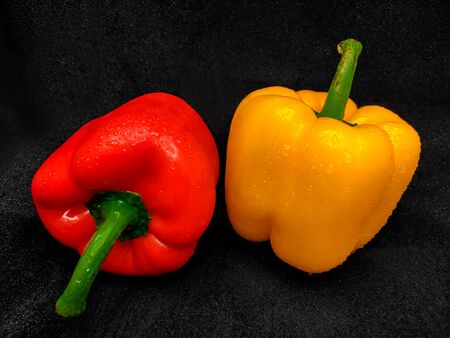 The bell pepper. Red and yellow tint on a black backgroundの写真素材