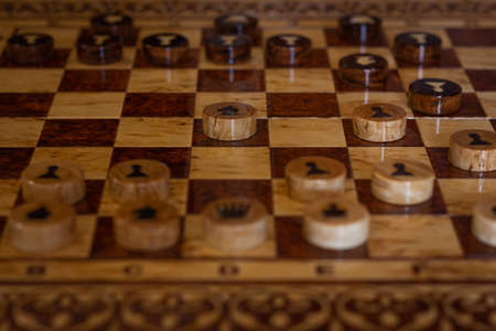 Board games wooden board of backgammon (tawla). Close-up details and checkers