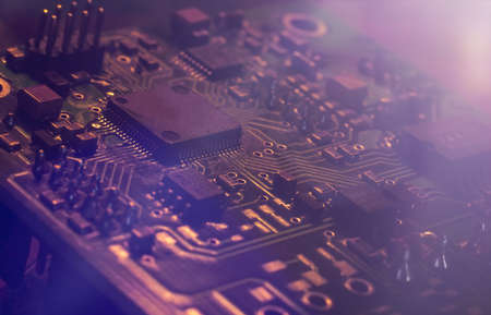 Kind over lilac neon abstract tech computer background. Printed circuit board (PCB) and electronic components of the chip. Artificial intelligence and technologyの写真素材