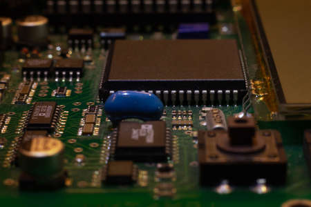 Macro close-up shot of green circuit board, computer motherboard Components: microcircuits, processor, transistors, semiconductors. Inside an electronic device, parts of a supercomputer.の写真素材