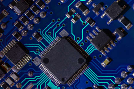 High-tech electronic board (PCB) with processor, microcircuits and luminous digital electronic signals. Close up macro photographyの写真素材