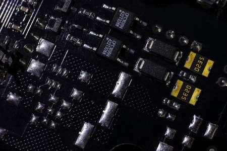 Black motherboard (PCB) digital chip. Technical science background. Integrated communication processor. Information and engineering component. Programming and technologyの写真素材