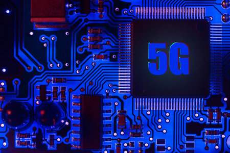 Close-up of a modern blue printed circuit board (PCB) with stripes of conductors between the...