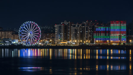 Panorama of the Kazan embankment, a Ferris wheel in the night illumination near the Kazan Kremlin on the bank of the Kazanka River, Kazan, Russiaのeditorial素材