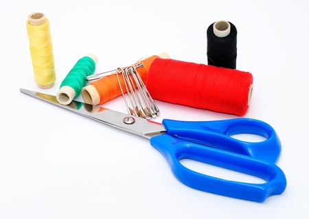 Blue scissors and various colored threads. 