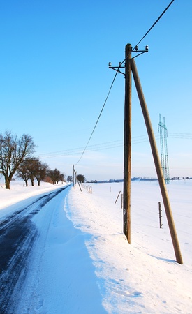 Winter road with power line.の写真素材