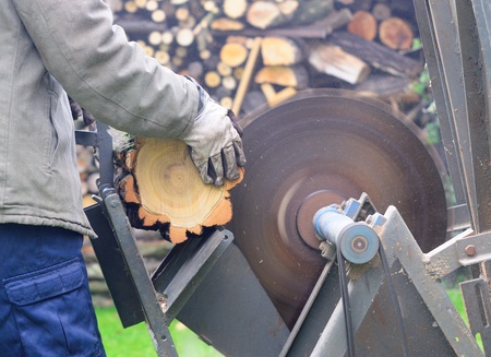 Man sawing wood on the circular saw.の写真素材