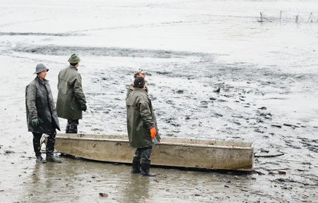 VAVRINEC, CZECH REPUBLIC - OCTOBER 28: Unidentified fisherman fishing carp at Vavrinec pond on October 28, 2011 in Vavrinec, Czech Republic.のeditorial素材