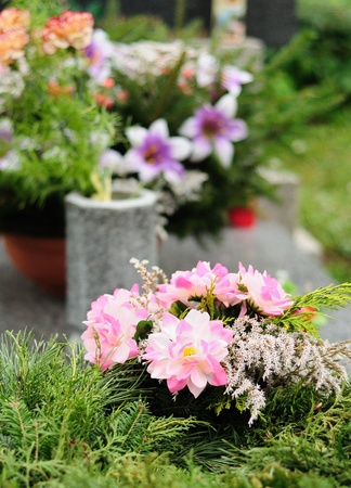 Funeral flowers placed on the grave at All souls holiday.の写真素材