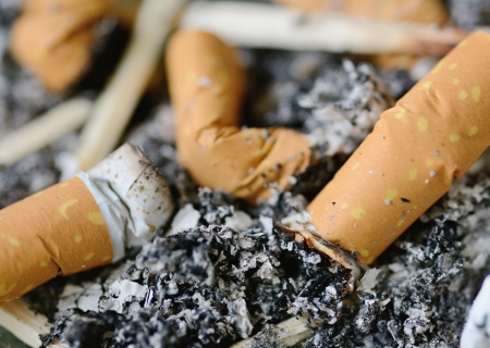 Macro shot with full ashtray with lot of butts の写真素材