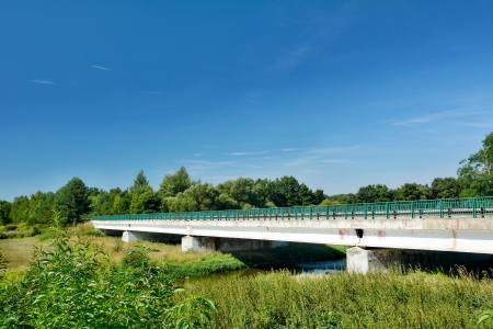 Old concrete road bridge over the river の写真素材