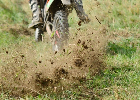 Flying mud from moving motorcycles enduro wheel 
