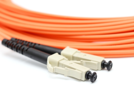 Orange optical cable on the white background macro 