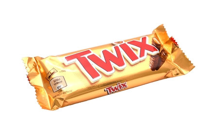 PRAGUE, CZECH REPUBLIC - MARCH 25, 2015: Wrapped candy bar TWIX isolated on a white background. It contains cookie and caramel, with chocolate topping. Twix bars are typically packaged in pairs. It is produced by Mars, incorporated.のeditorial素材