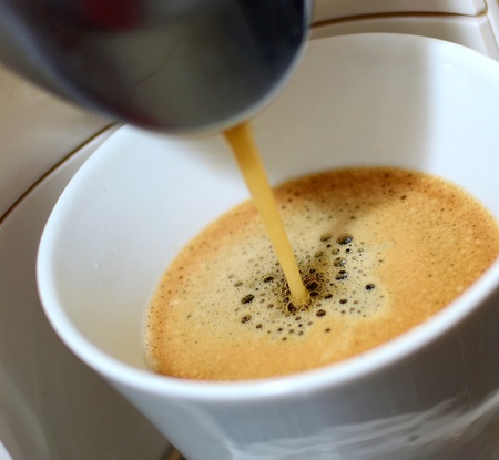 Closeup shot of an hot fresh espresso pouring to the cup  in espresso machine.の写真素材