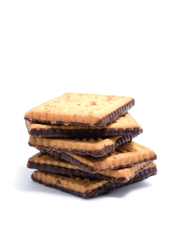 Stack of butter cookies with dark chocolate topping on a white background.の写真素材
