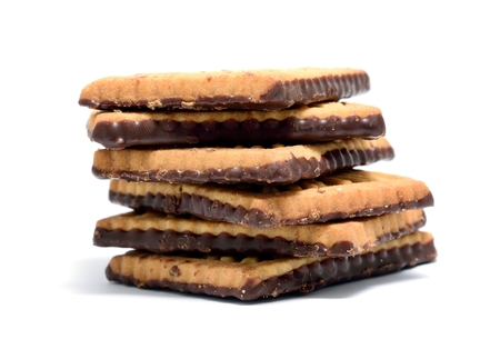 Stack of butter cookies with dark chocolate topping on a white background.の写真素材
