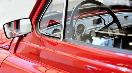 Side view through a window to interior of classic vintage red car.の写真素材