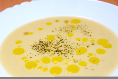 Vichyssoise soup with olive oil spills and parsley in white plate.の写真素材