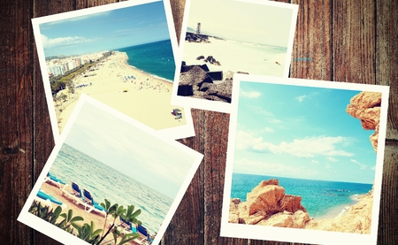 Heap of the vintage photos from summer holiday with traditional white frame placed on wooden desk.の写真素材