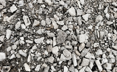 Top down view on a grey gravel stones texture. Background shot.の写真素材