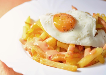 A Plate of French Fries with Fried Egg and Chilli Mayonnaise.の写真素材