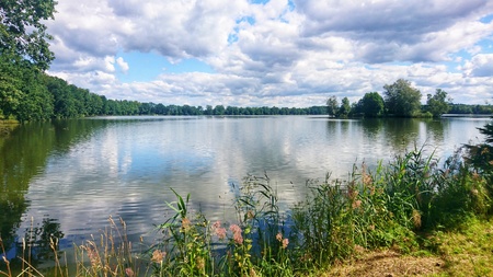 Scenic view of pond against dramatic sky with clouds in South Bohemia, near Trebon city. One of the many ponds near Trebon city in Trebon region.の写真素材