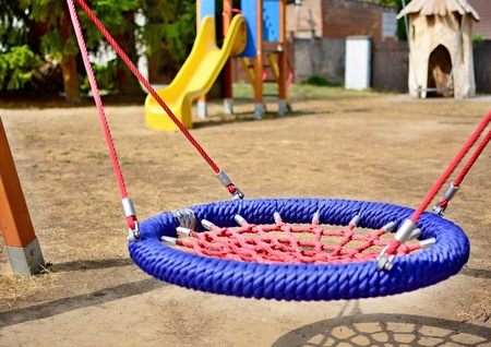Close-up of colorful blue-red nest swing seat in the playground.の写真素材