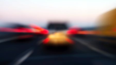 Zoom blur of rear lights of cars in motion on highway.の写真素材