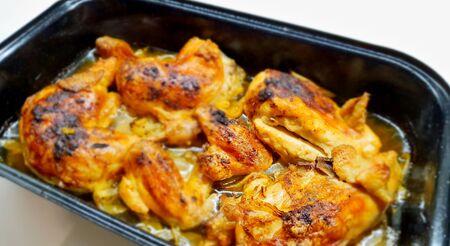 Top View of Pan Full of Oven-Baked Chicken Legs and Chicken Quartersの写真素材