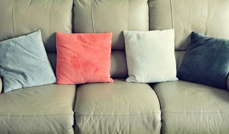 Full frame shot of light brown leather sofa with color suede pillows.の写真素材