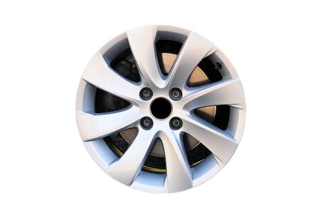 Modern alloy car disk without tire with four screws and brake disk isolated on white background.の写真素材