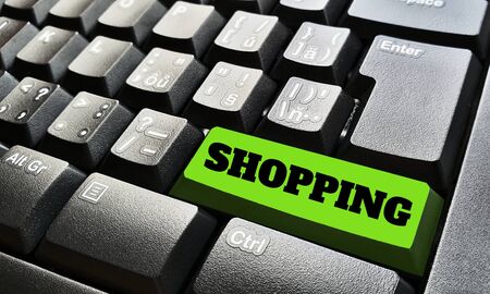 Black keyboard with one green key labeled by shopping sign.の写真素材