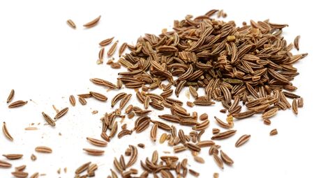 Scattered caraway seeds on white background.の写真素材