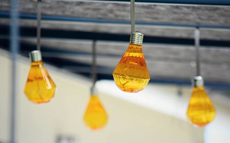 Closeup of hanging orange party bulbs on terrace roof. の写真素材