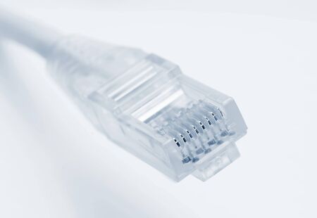 Closeup of rj45 connector of patch cable for LAN connection over white background.
